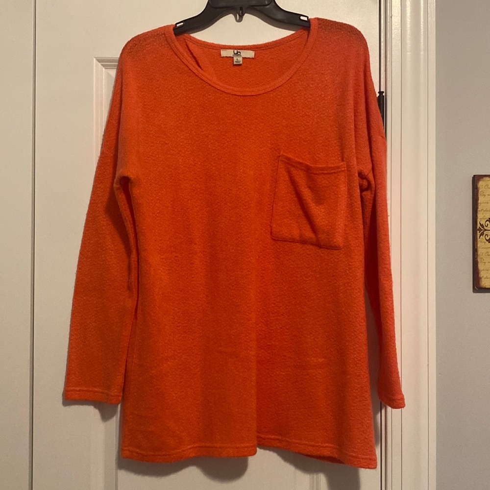 Coral sweater with open back and front pocket